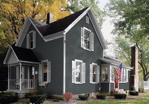 grey house with metal roof|dark grey brick house.